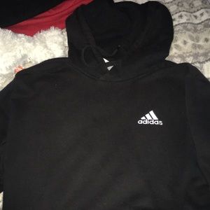 This is a black adidas hoodie with white lettering on the front it’s a size M